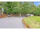 Spacious gravel parking area with a covered carport and additional parking space at 211 Drive Inn Rd, Locust, NC 28097