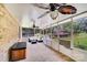Bright sunroom with carpet, ceiling fans, a hot tub, and views of the lush backyard at 211 Drive Inn Rd, Locust, NC 28097