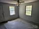 Bedroom with two windows, blank walls, and an overhead ceiling fan with lights at 211 Putnam St, Shelby, NC 28152