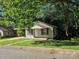 Exterior view of house featuring an overgrown lawn and brown shutters at 211 Putnam St, Shelby, NC 28152