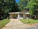 Modest single-story home with a driveway and a small front yard shaded by mature trees at 211 Putnam St, Shelby, NC 28152