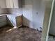 Kitchen featuring white cabinets, a countertop, and access to a laundry area at 211 Putnam St, Shelby, NC 28152