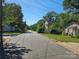 Quiet street view featuring a neighborhood with mature trees and sidewalks on a sunny day at 211 Putnam St, Shelby, NC 28152