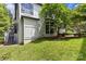 Exterior showcasing lawn with lush greenery, an elevated deck, and natural light at 224 Wendover Heights Cir, Charlotte, NC 28211