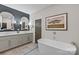 Modern primary bathroom with dual vanity, freestanding tub, and stylish fixtures, exuding luxury at 224 Wendover Heights Cir, Charlotte, NC 28211