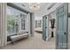 Inviting sitting room area with a bench and large windows leading to the adjacent main bedroom at 224 Wendover Heights Cir, Charlotte, NC 28211