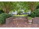 Charming courtyard featuring a small fountain, mature trees, and brick walkways at 224 Wendover Heights Cir, Charlotte, NC 28211