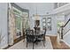 Elegant dining area with a chandelier, hardwood floors and large windows creating a bright atmosphere at 224 Wendover Heights Cir, Charlotte, NC 28211