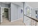 Spacious second-floor hallway with neutral carpet and fresh light blue paint, leading to arched entryways at 224 Wendover Heights Cir, Charlotte, NC 28211