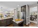 Modern kitchen island featuring granite countertops, barstool seating, and wine cooler at 224 Wendover Heights Cir, Charlotte, NC 28211