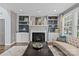 Cozy living room with built-in shelving, fireplace, and large windows for natural light at 224 Wendover Heights Cir, Charlotte, NC 28211