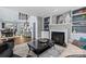 Spacious living room with fireplace and views into the dining room, with stylish decor and comfortable seating at 224 Wendover Heights Cir, Charlotte, NC 28211