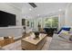Stylish living room with kitchen access, features natural light, modern decor, and hardwood floors at 224 Wendover Heights Cir, Charlotte, NC 28211