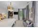 Bright main bedroom showing a cozy seating area, window views, and entry to a custom closet at 224 Wendover Heights Cir, Charlotte, NC 28211