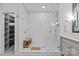 Luxurious walk-in shower with elegant marble tile, a built-in bench, and glass enclosure at 224 Wendover Heights Cir, Charlotte, NC 28211