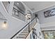Bright foyer with a staircase featuring dark wood treads, white risers, and a wrought iron railing at 224 Wendover Heights Cir, Charlotte, NC 28211
