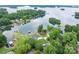 Serene aerial view of a home nestled on a waterfront property, surrounded by lush greenery at 2593 Las Brisas Ln, Denver, NC 28037