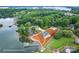 Waterfront property with beautiful landscape featuring a home with private dock surrounded by lush trees on the lake at 2593 Las Brisas Ln, Denver, NC 28037