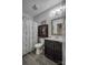 Cozy bathroom with a shower-tub combo, dark wood vanity, and wood-look tile flooring for a comfortable experience at 2593 Las Brisas Ln, Denver, NC 28037