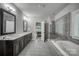 Elegant bathroom with double vanity, soaking tub, and glass-enclosed shower at 2593 Las Brisas Ln, Denver, NC 28037