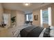 Comfortable bedroom featuring neutral paint, bright windows, and walk-in closet at 2593 Las Brisas Ln, Denver, NC 28037