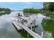 The boat dock features a two-story deck with tables and chairs for lounging by the water at 2593 Las Brisas Ln, Denver, NC 28037