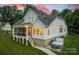 Beautiful home exterior features a screened porch, manicured lawn, and relaxing hot tub for outdoor enjoyment at 2593 Las Brisas Ln, Denver, NC 28037
