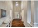 Elegant foyer with high ceilings, a statement light fixture, and hardwood floors at 2593 Las Brisas Ln, Denver, NC 28037