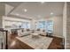 Open-concept living room with lake views, hardwood floors, and stylish furniture at 2593 Las Brisas Ln, Denver, NC 28037