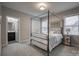 Inviting main bedroom with a four-poster bed, soft carpeting, and private bathroom access for comfort and convenience at 2593 Las Brisas Ln, Denver, NC 28037