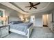 Spacious main bedroom with tray ceiling, lake views, and neutral decor at 2593 Las Brisas Ln, Denver, NC 28037