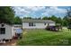 View of the backyard featuring a shed, playhouse, and lush lawn at 2843 Hopewell Church Rd, Sherrills Ford, NC 28673