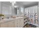 Bright bathroom with a double sink vanity, wood-look floors, and a shower-tub combo at 2843 Hopewell Church Rd, Sherrills Ford, NC 28673