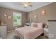 Bedroom with a pink bedspread, a white metal frame and natural light at 2843 Hopewell Church Rd, Sherrills Ford, NC 28673