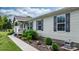 Single-story home with gray siding, black shutters, and a landscaped walkway leading to the covered front porch at 2843 Hopewell Church Rd, Sherrills Ford, NC 28673