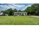Spacious front yard with a charming single-story home nestled among mature trees, offering privacy and curb appeal at 2843 Hopewell Church Rd, Sherrills Ford, NC 28673