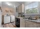 The kitchen features stainless steel appliances and white cabinets, plus a window to the backyard at 2843 Hopewell Church Rd, Sherrills Ford, NC 28673