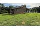Spacious backyard featuring grass and a back deck with stairs at 28835 Hartsell Rd, Albemarle, NC 28001