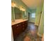 Bathroom features a double sink vanity with marble top, tile flooring, and a tiled shower at 28835 Hartsell Rd, Albemarle, NC 28001