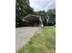 Carport with white metal frame, gravel parking area, and green lawn surroundings at 28835 Hartsell Rd, Albemarle, NC 28001