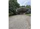Gravel parking area leading to a large metal carport structure at 28835 Hartsell Rd, Albemarle, NC 28001