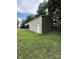 A spacious, steel outbuilding with a covered area in a large, green lawn at 28835 Hartsell Rd, Albemarle, NC 28001