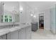 Stylish bathroom featuring double vanities, marble countertops, and a walk-in closet at 2941 Forest Park Dr, Charlotte, NC 28209