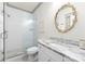 Bathroom with a glass-enclosed shower, marble vanity, and decorative mirror at 2941 Forest Park Dr, Charlotte, NC 28209