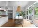 Bright dining area with stylish chairs, a unique light fixture, and access to a deck at 2941 Forest Park Dr, Charlotte, NC 28209