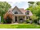 Charming home featuring stone accents, a cozy front porch, and lush landscaping at 2941 Forest Park Dr, Charlotte, NC 28209