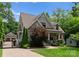Craftsman-style home with fenced driveway and lush green lawn at 2941 Forest Park Dr, Charlotte, NC 28209
