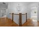 Hallway featuring hardwood floors, a statement chandelier, and staircase at 2941 Forest Park Dr, Charlotte, NC 28209