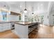 Open kitchen with center island with counter seating and white cabinets at 2941 Forest Park Dr, Charlotte, NC 28209