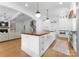 Well-lit kitchen featuring a large island, farmhouse sink, and stainless appliances at 2941 Forest Park Dr, Charlotte, NC 28209